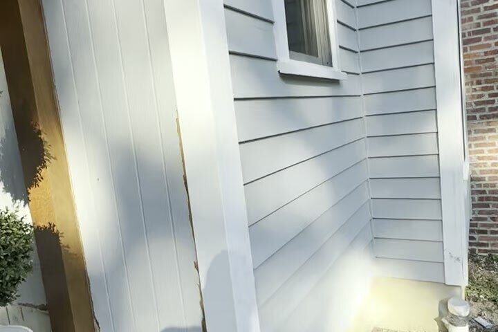 Finished gray lap siding with clean reveals and white trim.