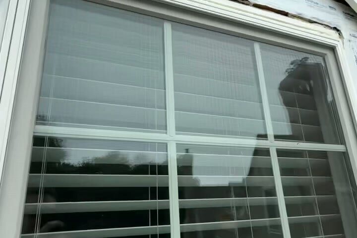 Newly installed window with fresh trim and weather flashing.